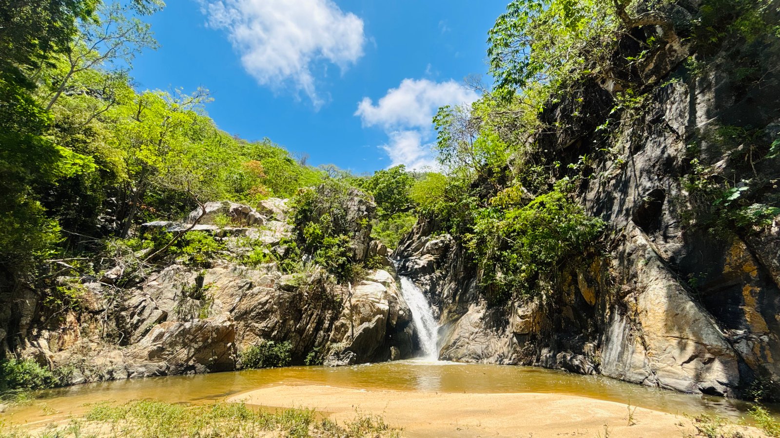 Waterfall with sandy pool